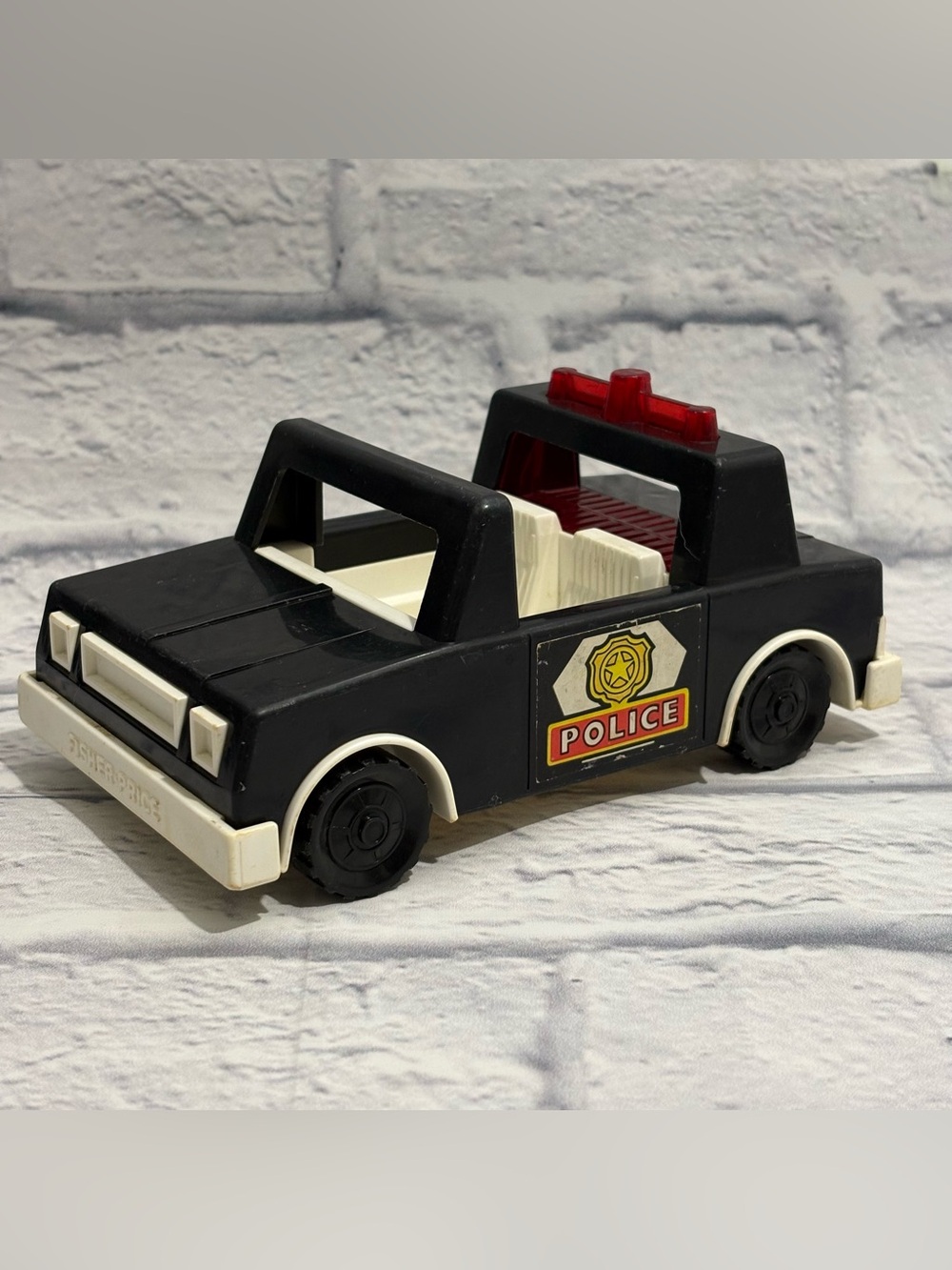 Vintage 1981 Fisher Price “Husky Helper” police car toy